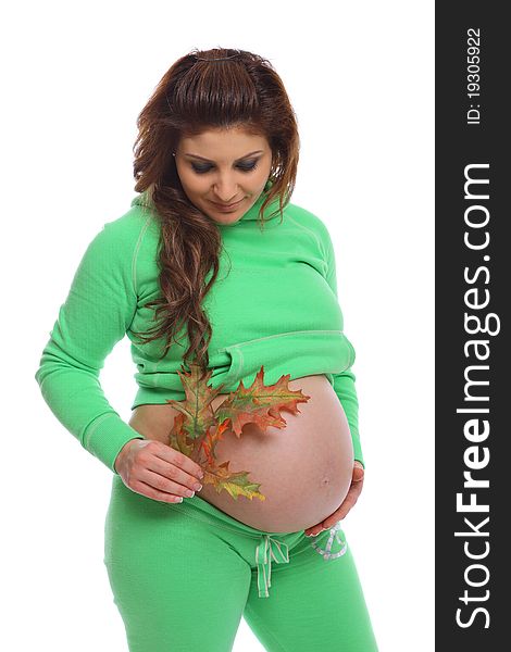 Pregnant woman holding a leaf next to her belly. Pregnant woman holding a leaf next to her belly