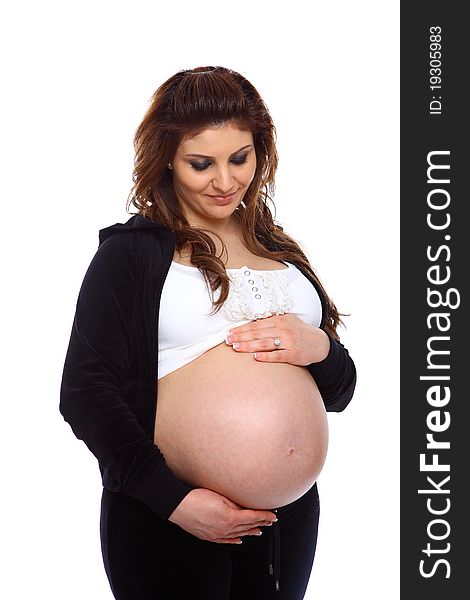 Pregnant woman holding her bare belly isolated on white