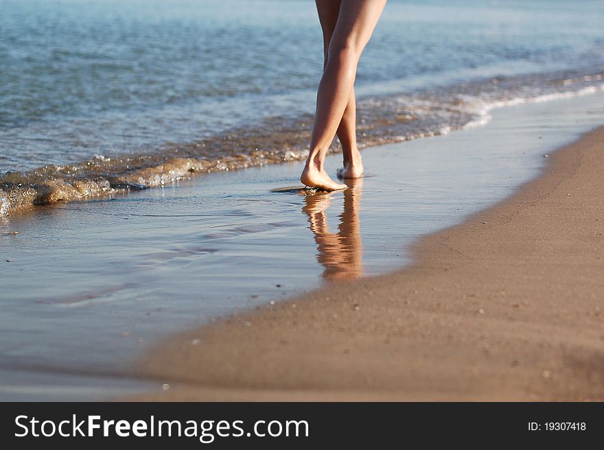 Girl's barefooted legs in water. Girl's barefooted legs in water