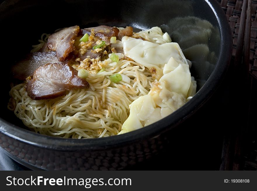 Asian noodle in black bowl