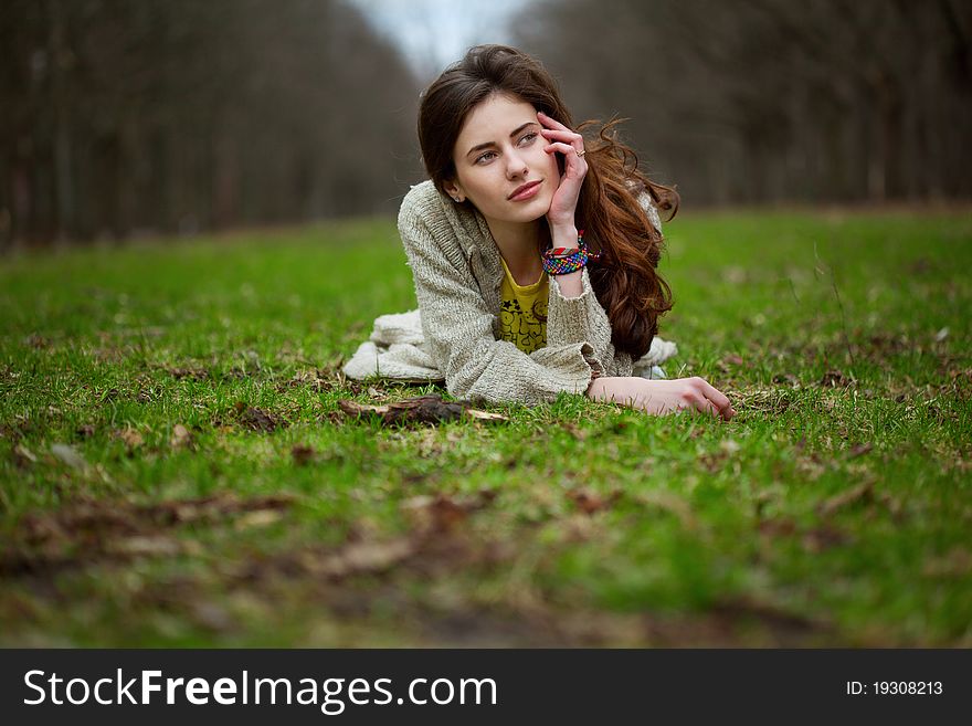 Young sweet girl lying in a grass