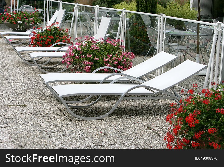 Furniture recliner gardens around a pool