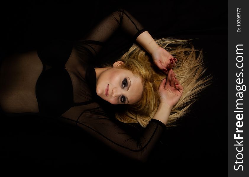 Sexy Blond laying on a black background