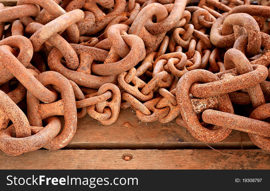 Old rusty chain on wooden background