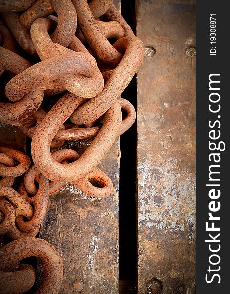 Rusty Chain On Wooden Background