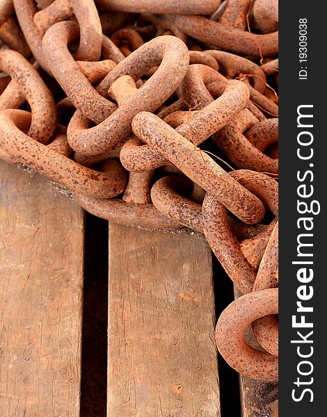 Old rusty chain on wooden background