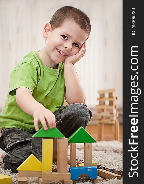 Little boy building a house with colorful wooden blocks. Little boy building a house with colorful wooden blocks