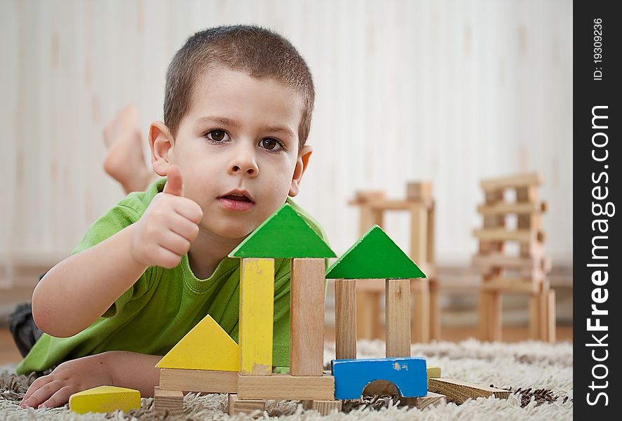 Little boy building a house with colorful wooden blocks. Little boy building a house with colorful wooden blocks