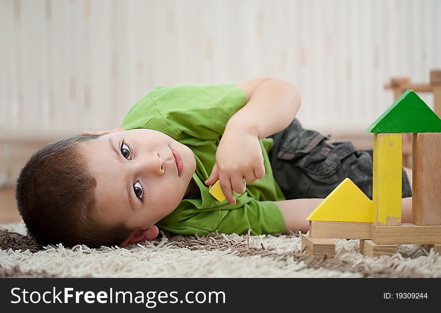 Little boy building a house with colorful wooden blocks. Little boy building a house with colorful wooden blocks