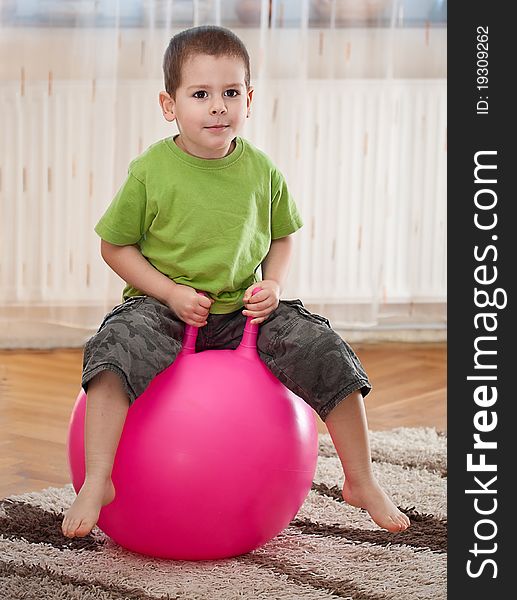 Boy play with large ball in room. Boy play with large ball in room
