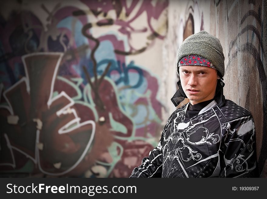 Paintball player near the wall with graffiti