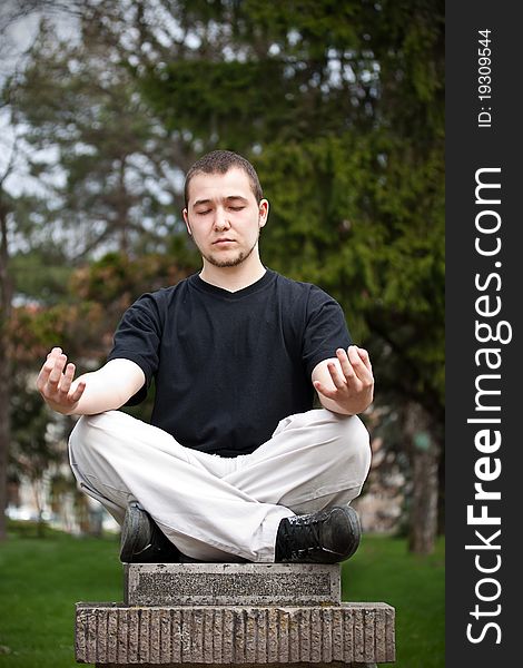 Man doing yoga at the park