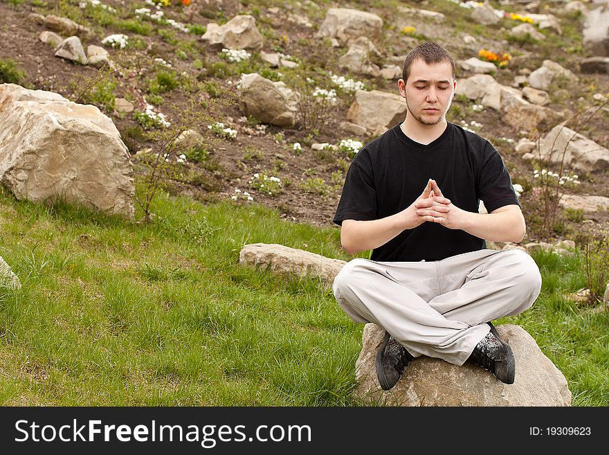 Man doing yoga at the park