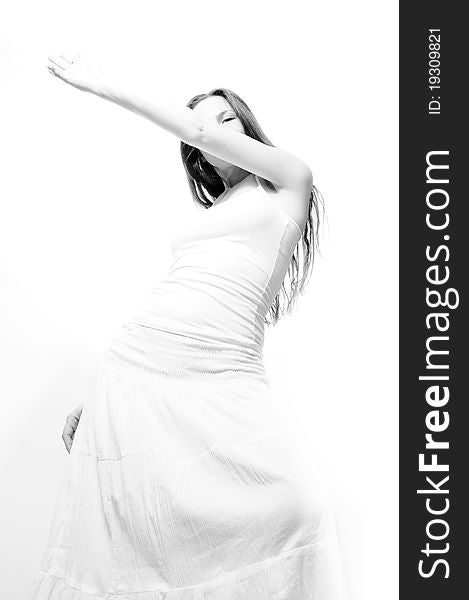 Girl in a white dress dancing on a white background. Girl in a white dress dancing on a white background