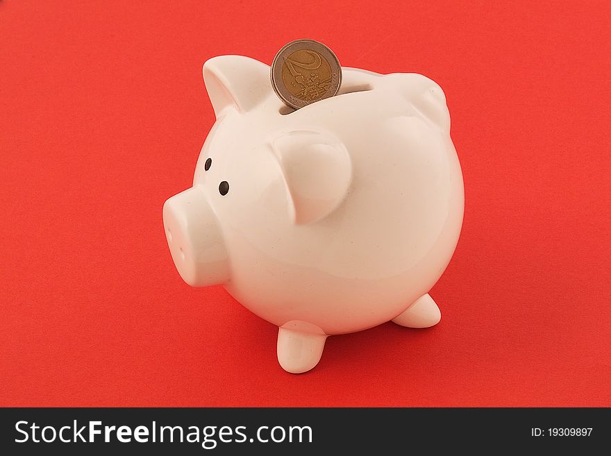 Piggy bank on red background