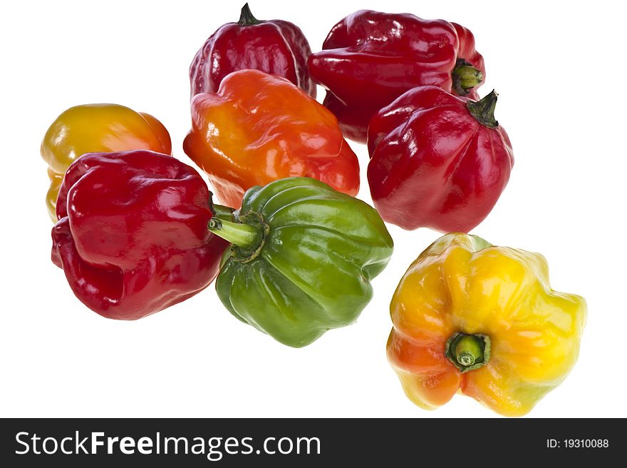 Some small exotic peppers on white background