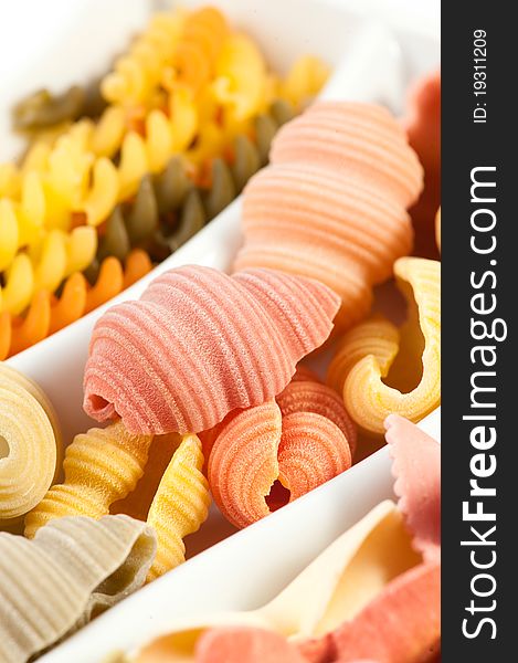 Different kinds of italian pasta on white background