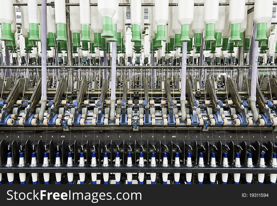 Jungle of textile yarn spinning machines. Jungle of textile yarn spinning machines