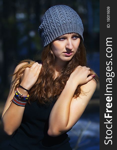 Beautiful smiling girl in a blue beret in park