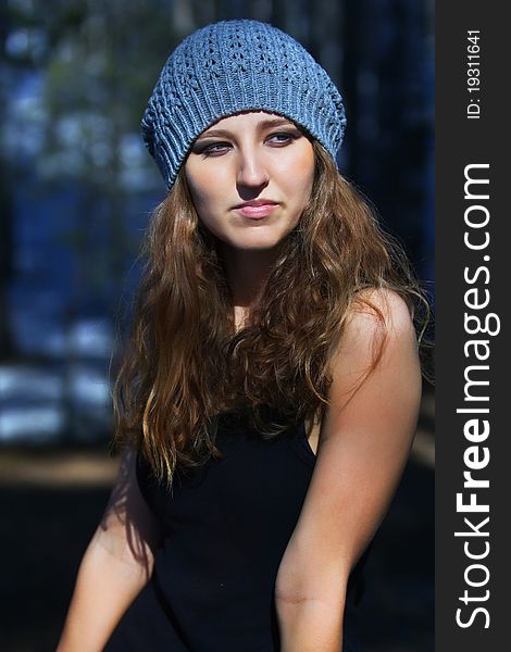 Beautiful smiling girl in a blue beret in park