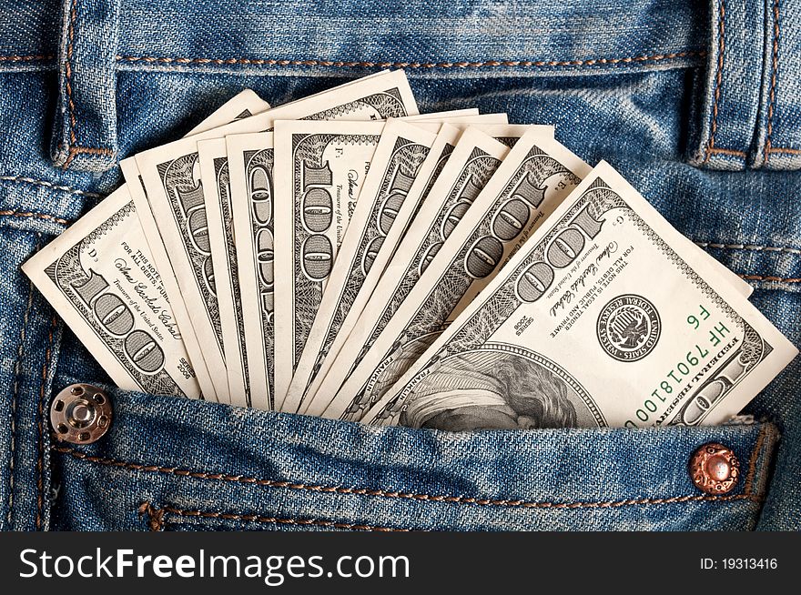 American dollar bills in jeans pocket background