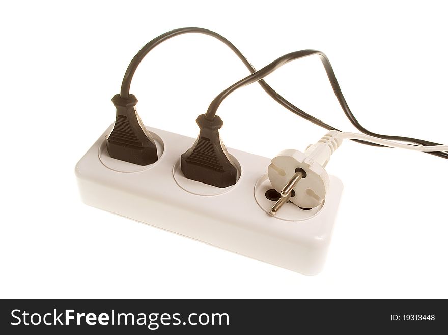 Three white and black electrical plugs into the outlet