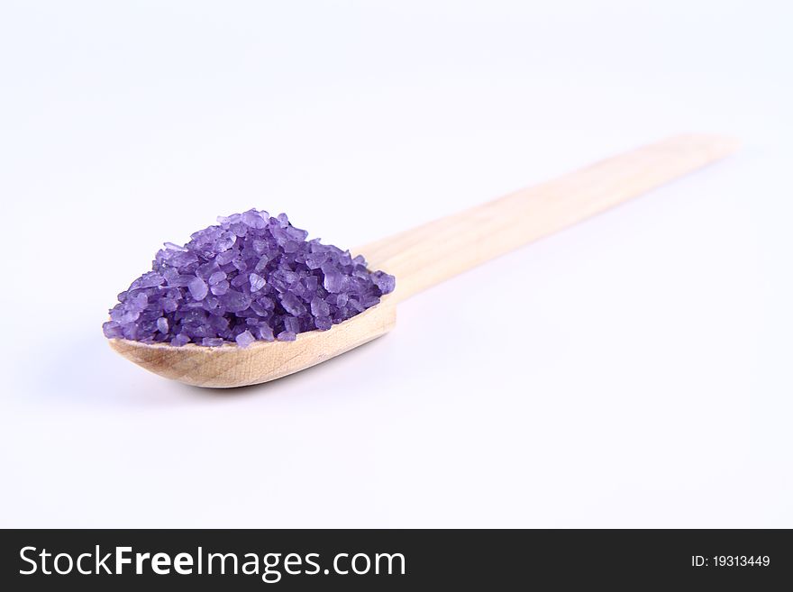 Lavender spa salt on a wooden spoon