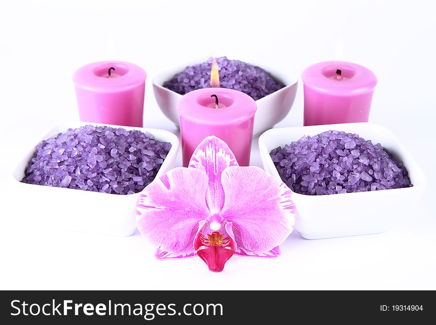 Lavender spa salt, an orchid flower and candles. Lavender spa salt, an orchid flower and candles