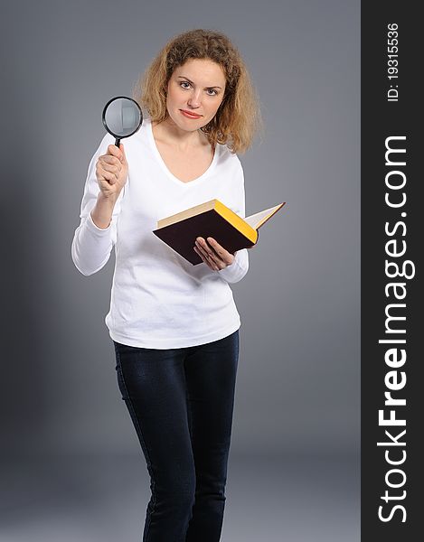 Woman Looking The Book With Magnifying Glass