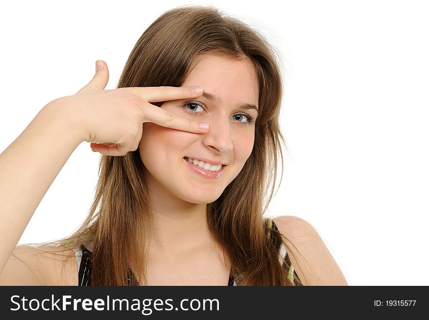 Woman holding up fingers and peeking between them. On a white background