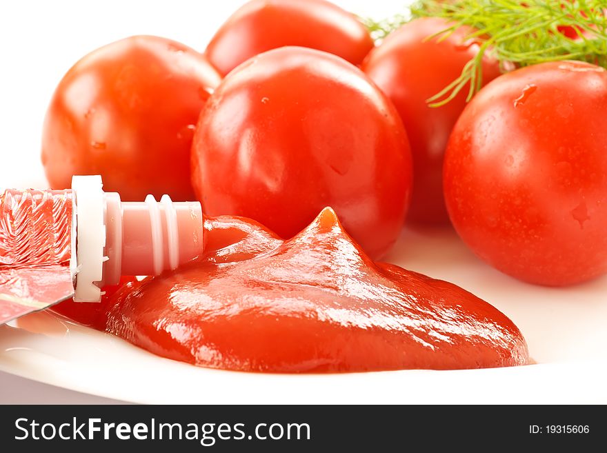 Fresh tomato ketchup on a background of ripe tomato
