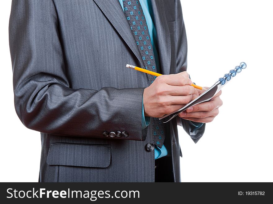 Businessman writing something in his notebook, notepad. Isolated on white background