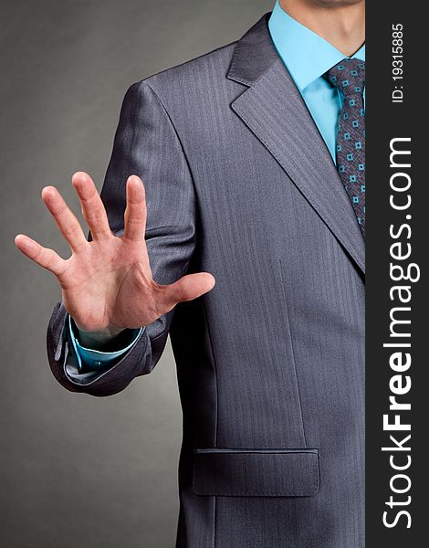 Businessman in suit and tie pointing the fingers palm in front of himself. Businessman in suit and tie pointing the fingers palm in front of himself