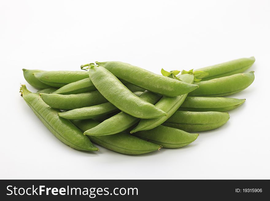 Fresh green pea in the pod on white background with soft shadow