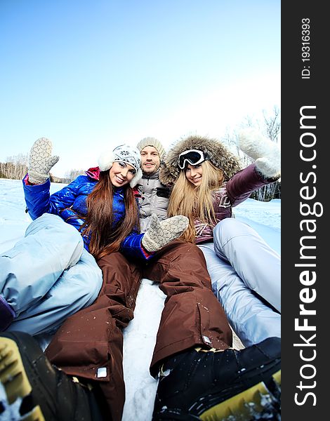 Group of young people having a rest outdoor in winter. Group of young people having a rest outdoor in winter.