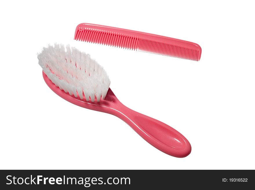 Newborn or baby pink soft hair brush and comb isolated. Newborn or baby pink soft hair brush and comb isolated