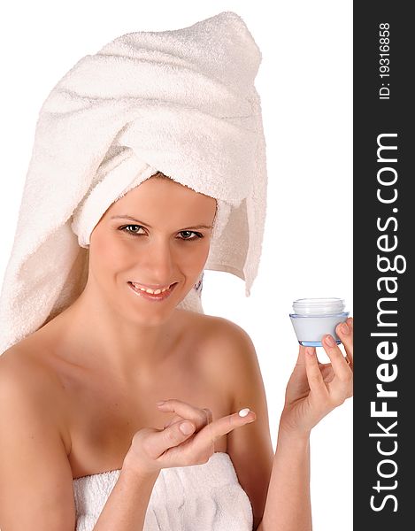 Young woman applying face cream. Young woman applying face cream.