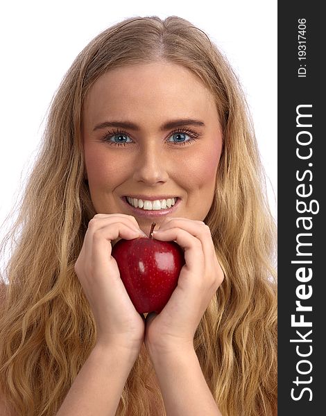 Beautiful blond caucasian young woman smiling and  holding a red apple, creating a heart with her hands. Beautiful blond caucasian young woman smiling and  holding a red apple, creating a heart with her hands