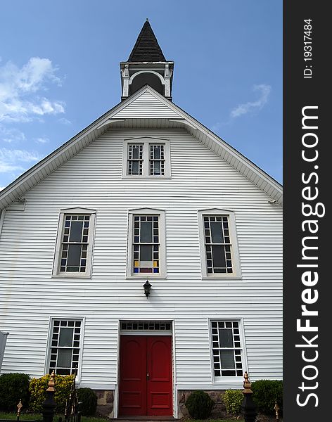 White wood church with red door. White wood church with red door