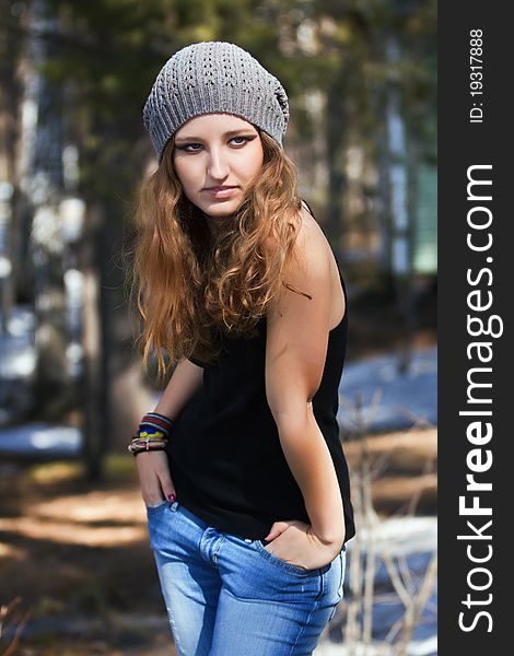 Beautiful smiling girl in a blue beret in park