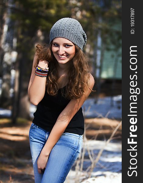 Beautiful smiling girl in a blue beret in park