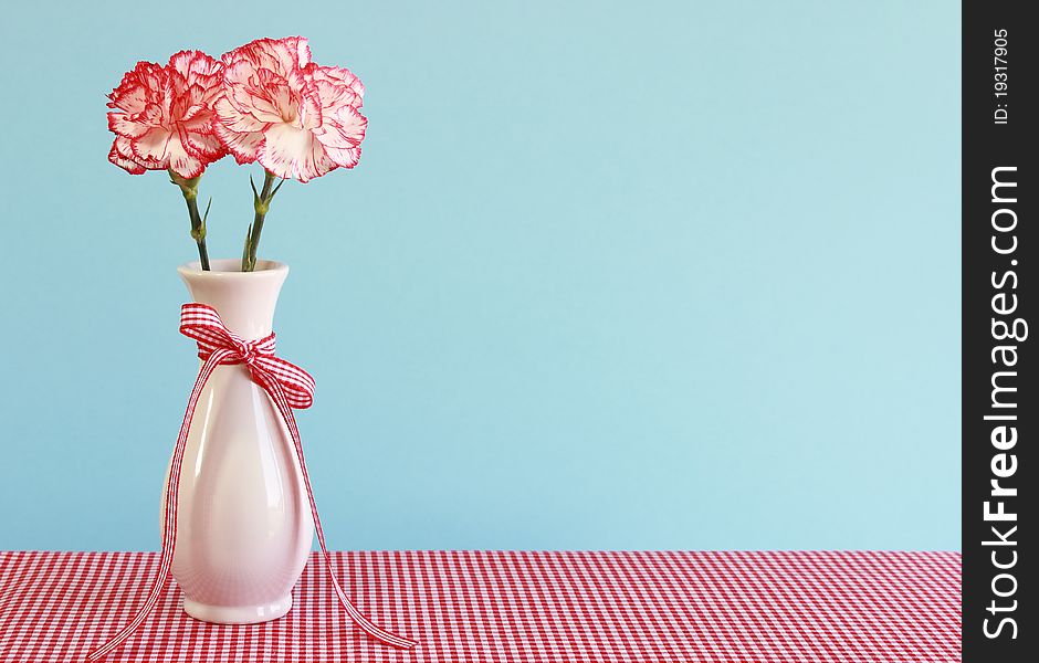 Red And White Carnations In A Vase