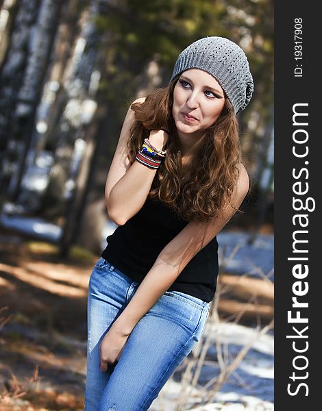 Beautiful smiling girl in a blue beret in park