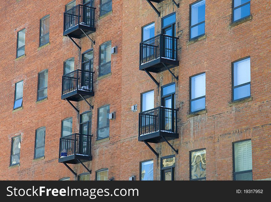 Fire escapes run down colorful apartment buildings in Calgary, Alberta, Canada