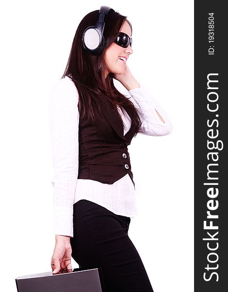 Beautiful woman listening music on her headphones isolated