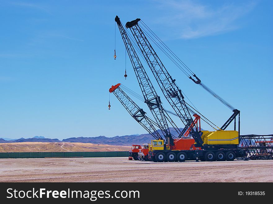 Three mechanical Cranes Parked in the Desert. Three mechanical Cranes Parked in the Desert
