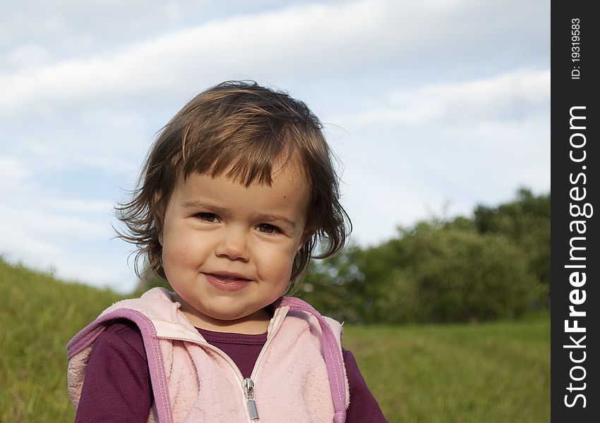 Portrait of a cute little girl smiling outdoors