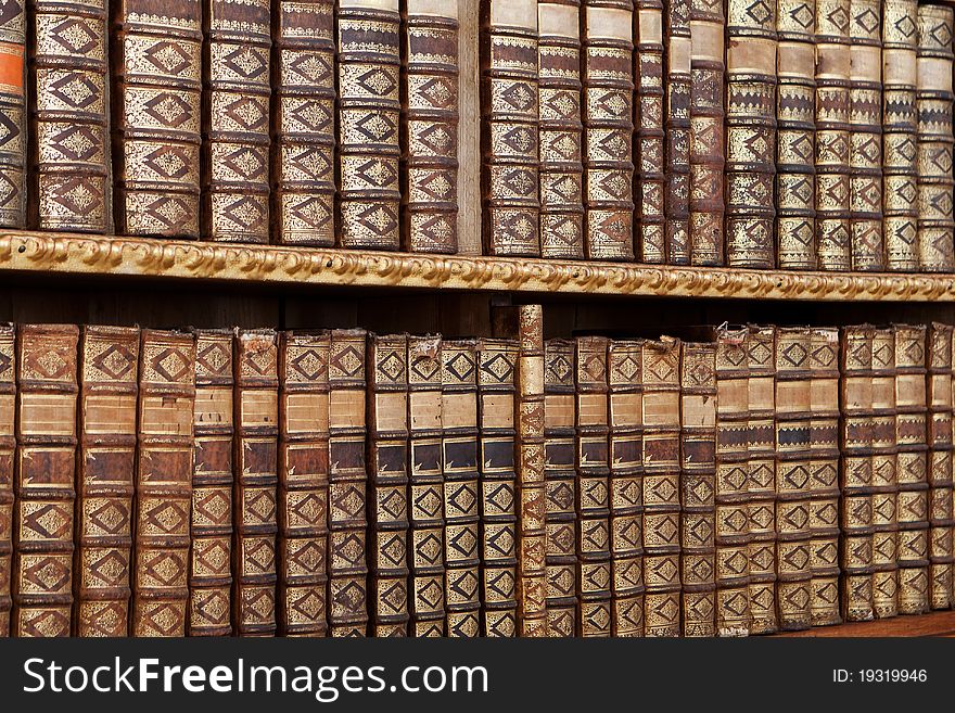 Old antique books, with hardcover in a row on shelf