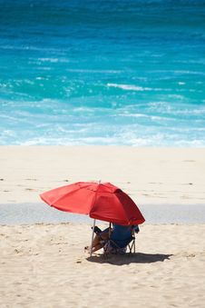 Beach Scene With Red Umbrella And Blue Water Stock Images Beach Scene With Red Umbrella And Blue Water Stock Images