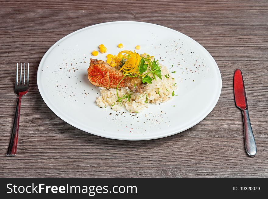 Chicken on a white plate with vegetables and rice. Chicken on a white plate with vegetables and rice